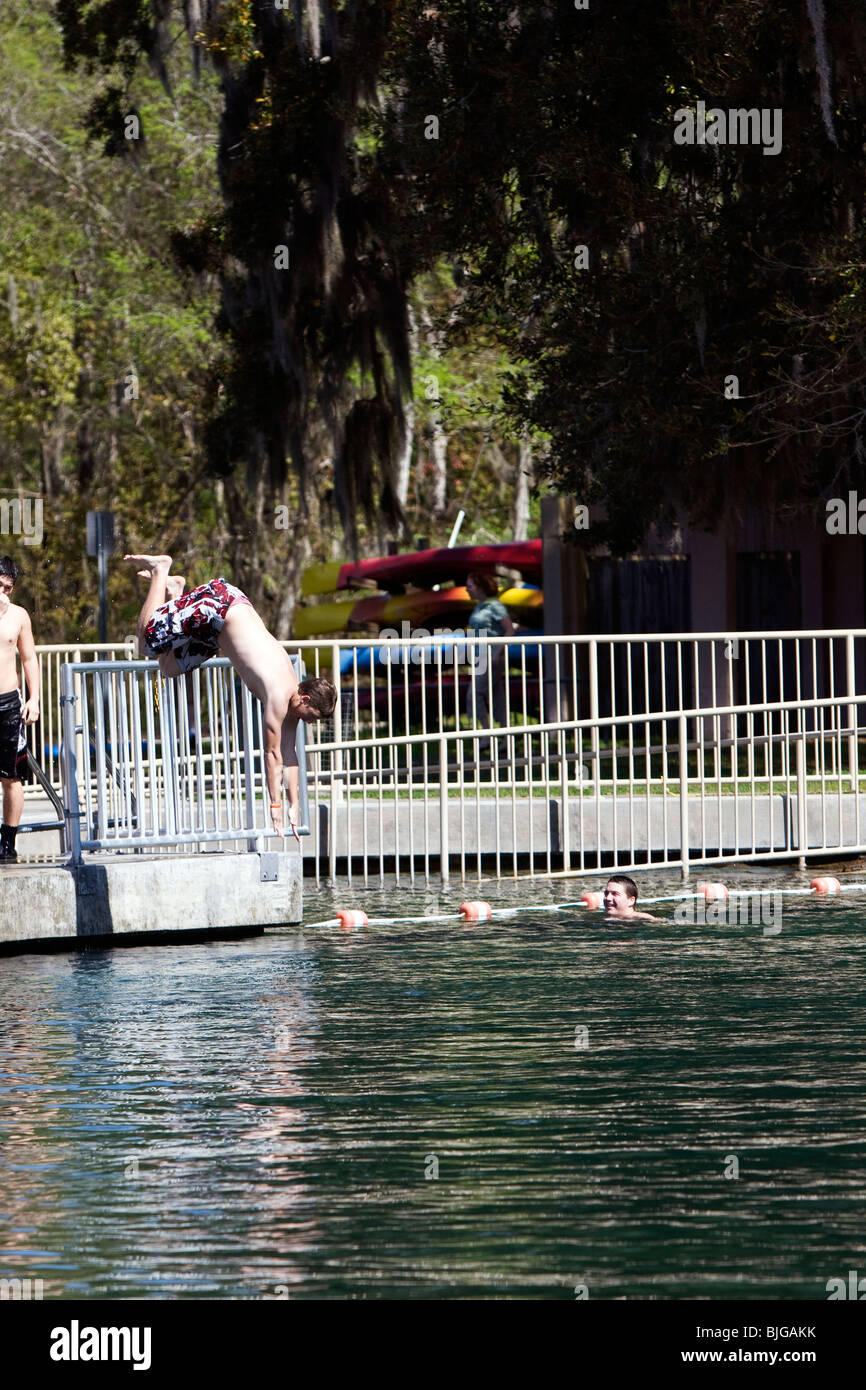 Teens diving in to De Leon Springs into cold water. Stock Photo