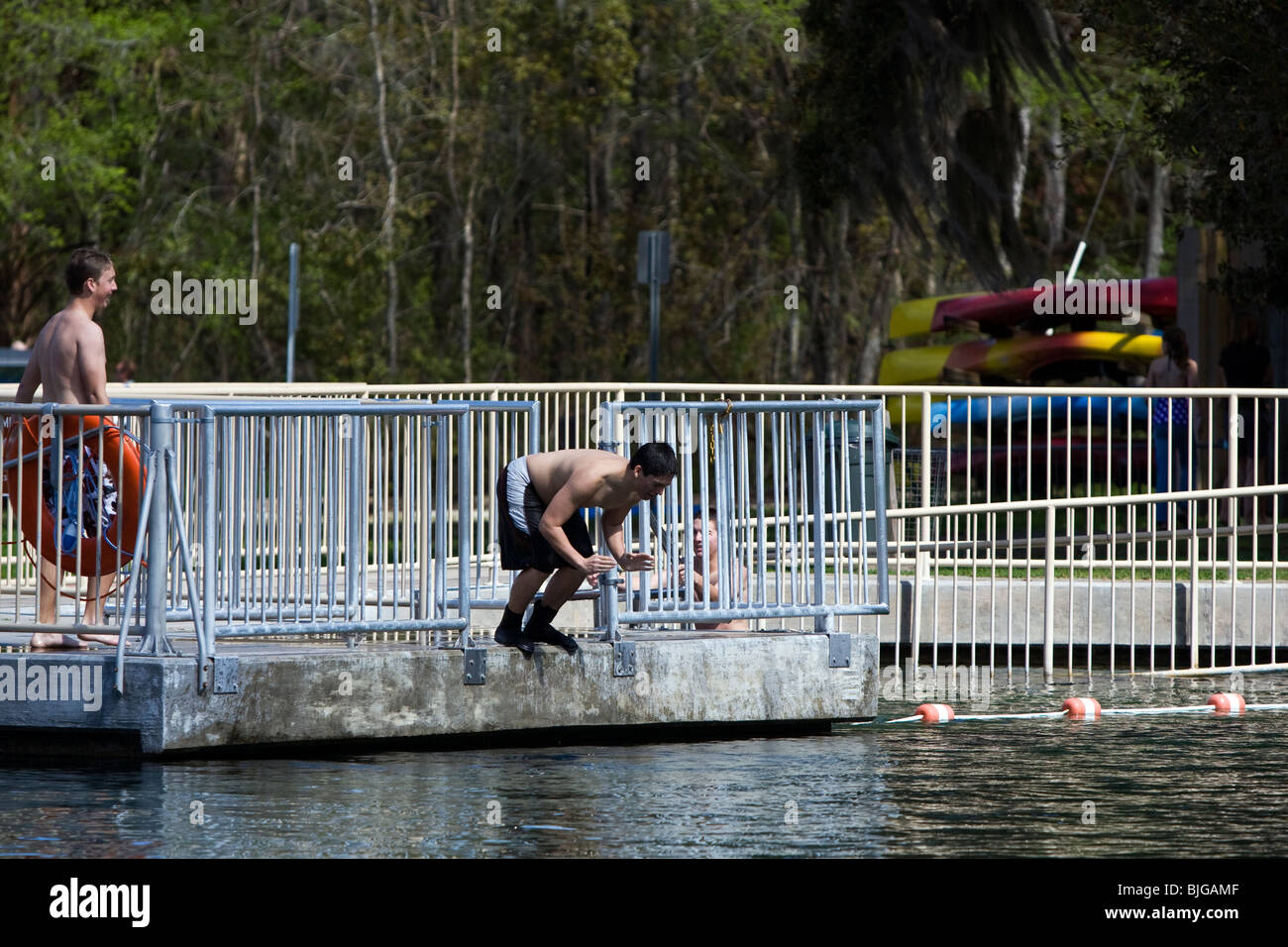 Teens diving in to De Leon Springs into cold water. Stock Photo