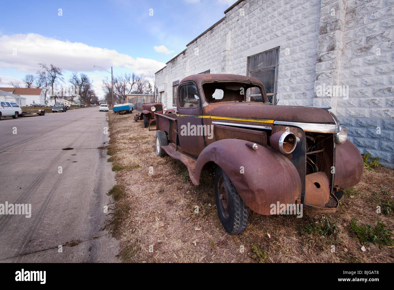 A rusted out antique Chevrolet pickup truck parked in rural Nebraska. Shot from public road. Stock Photo