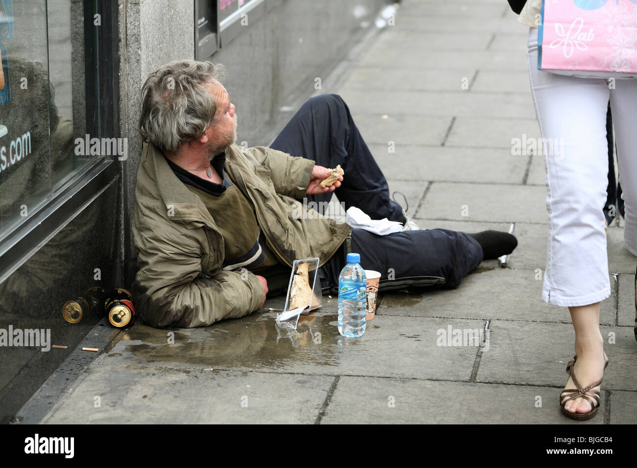 man-lying-on-a-sidewalk-dublin-ireland-BJGCB4.jpg