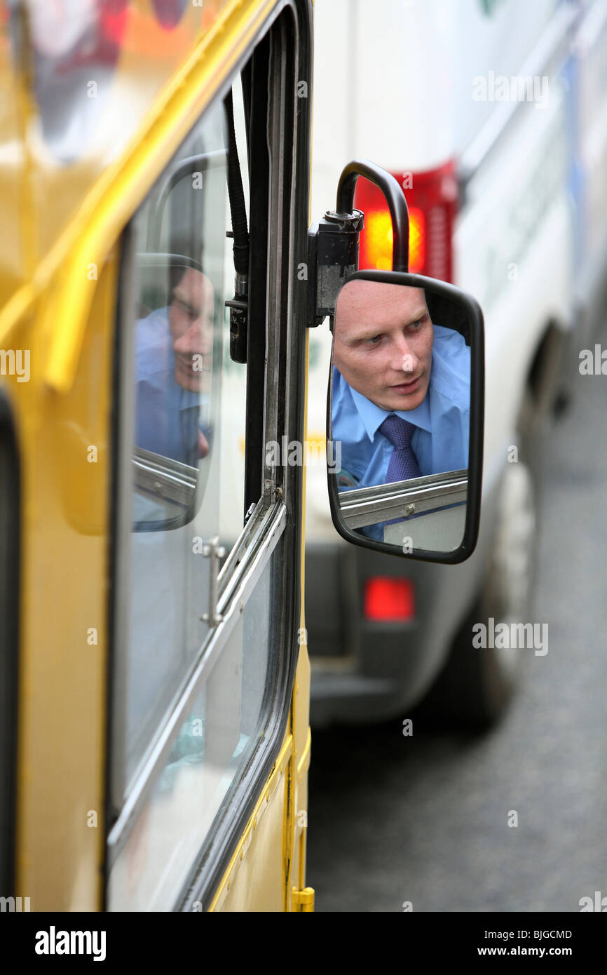 Bus driver's reflection in a side mirror, Dublin, Ireland Stock Photo
