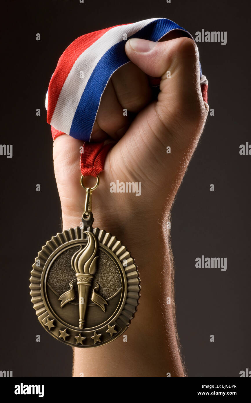 hand holding a gold medal Stock Photo