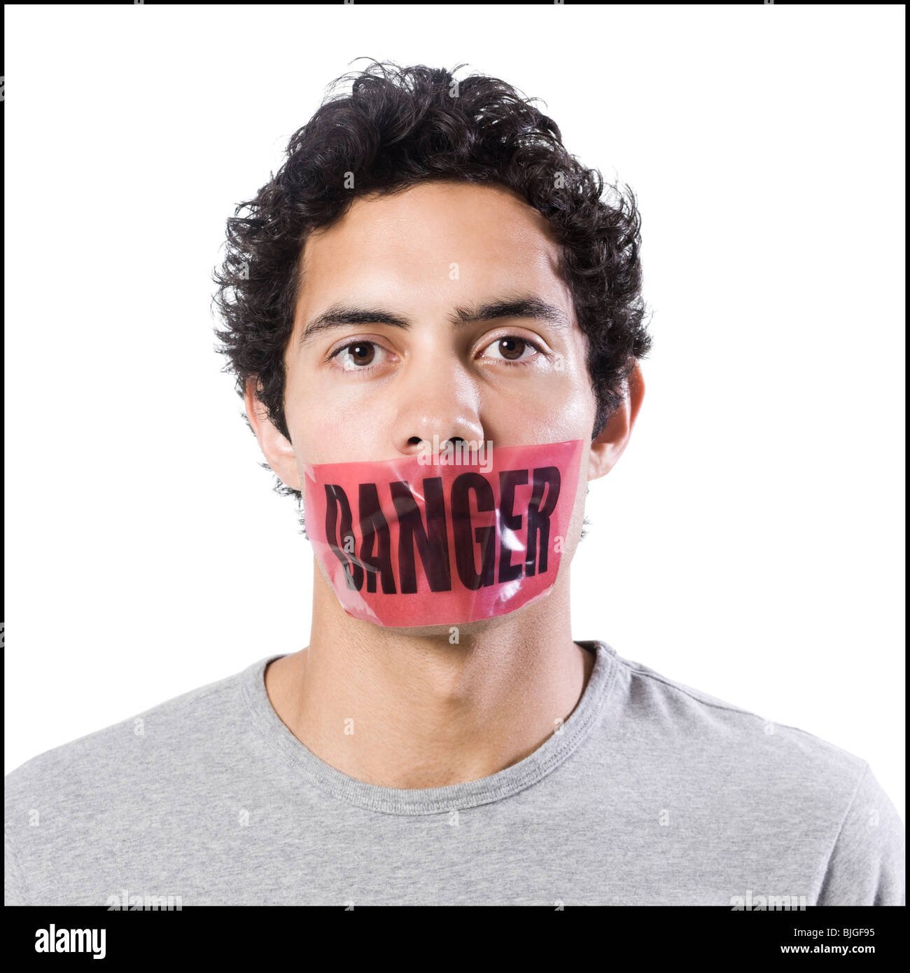 man with danger tape over mouth Stock Photo