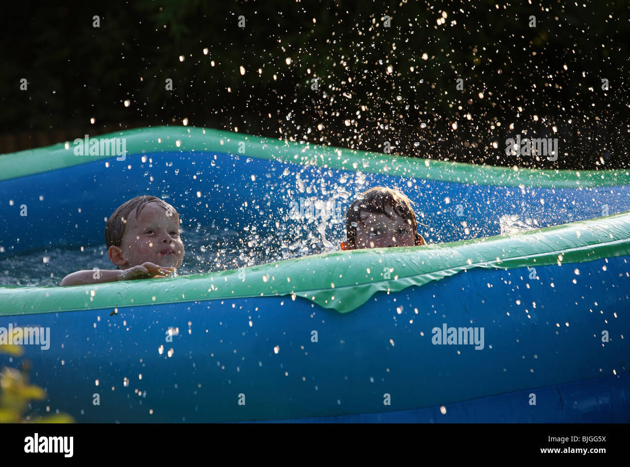 Kids playing in paddling pool Stock Photo Alamy