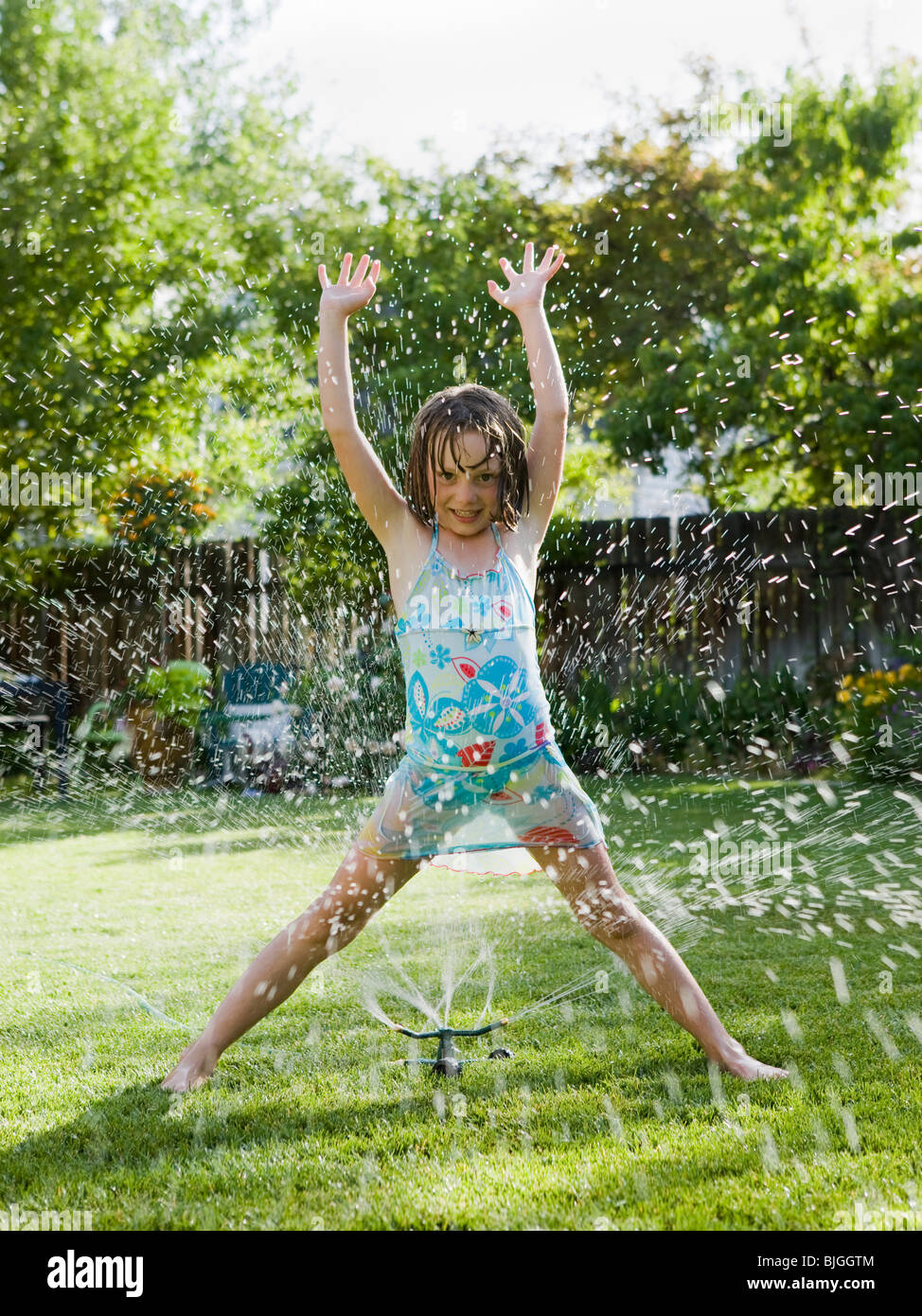 girl playing in a sprinkler Stock Photo - Alamy