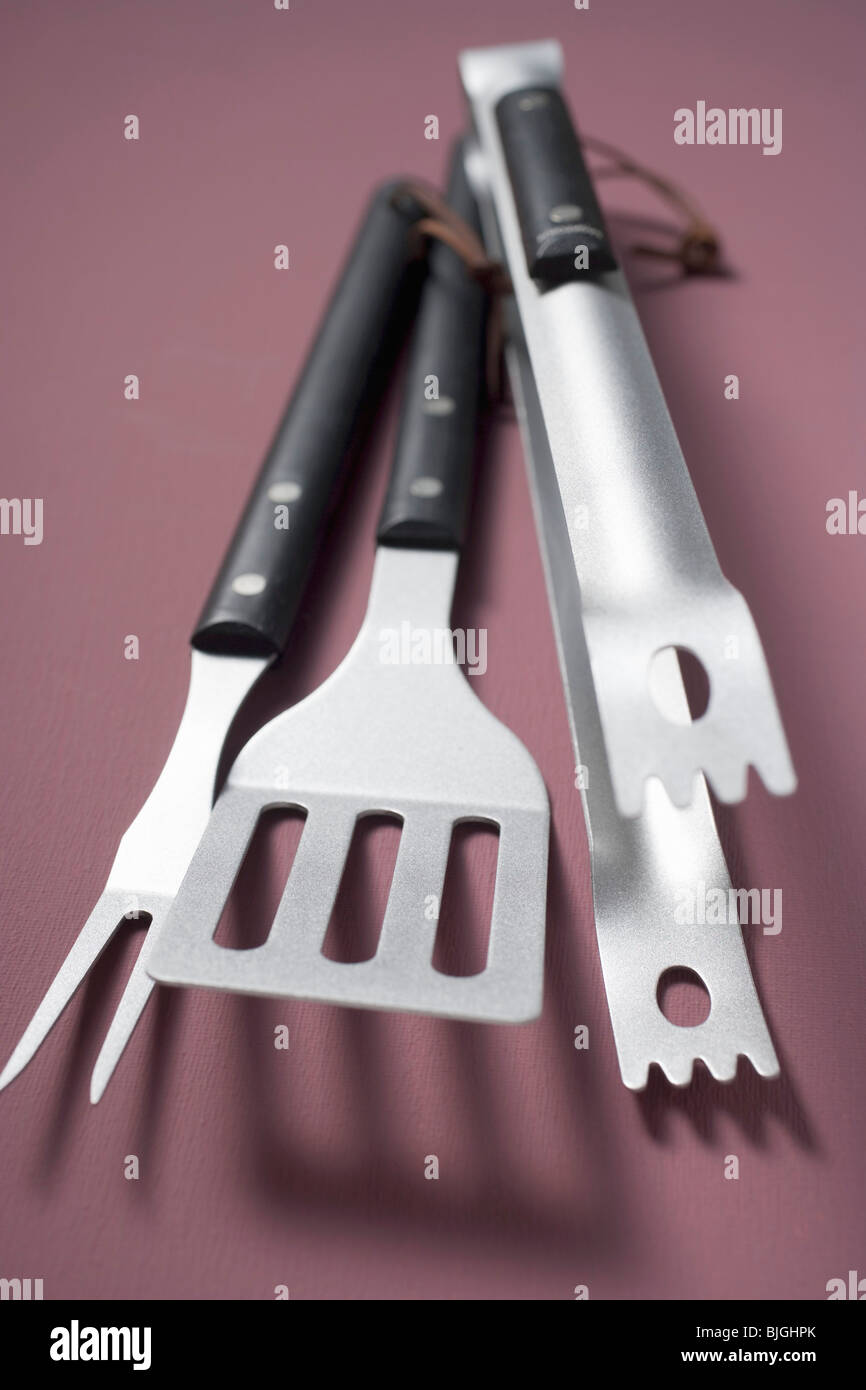 Barbecue tools (tongs, spatula, carving fork) - Stock Photo