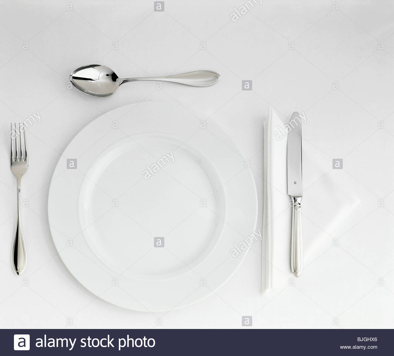 Table Setting with White Plate, Cutlery & Triangular Napkin Stock ... Table Setting with White Plate, Cutlery & Triangular Napkin Stock ...