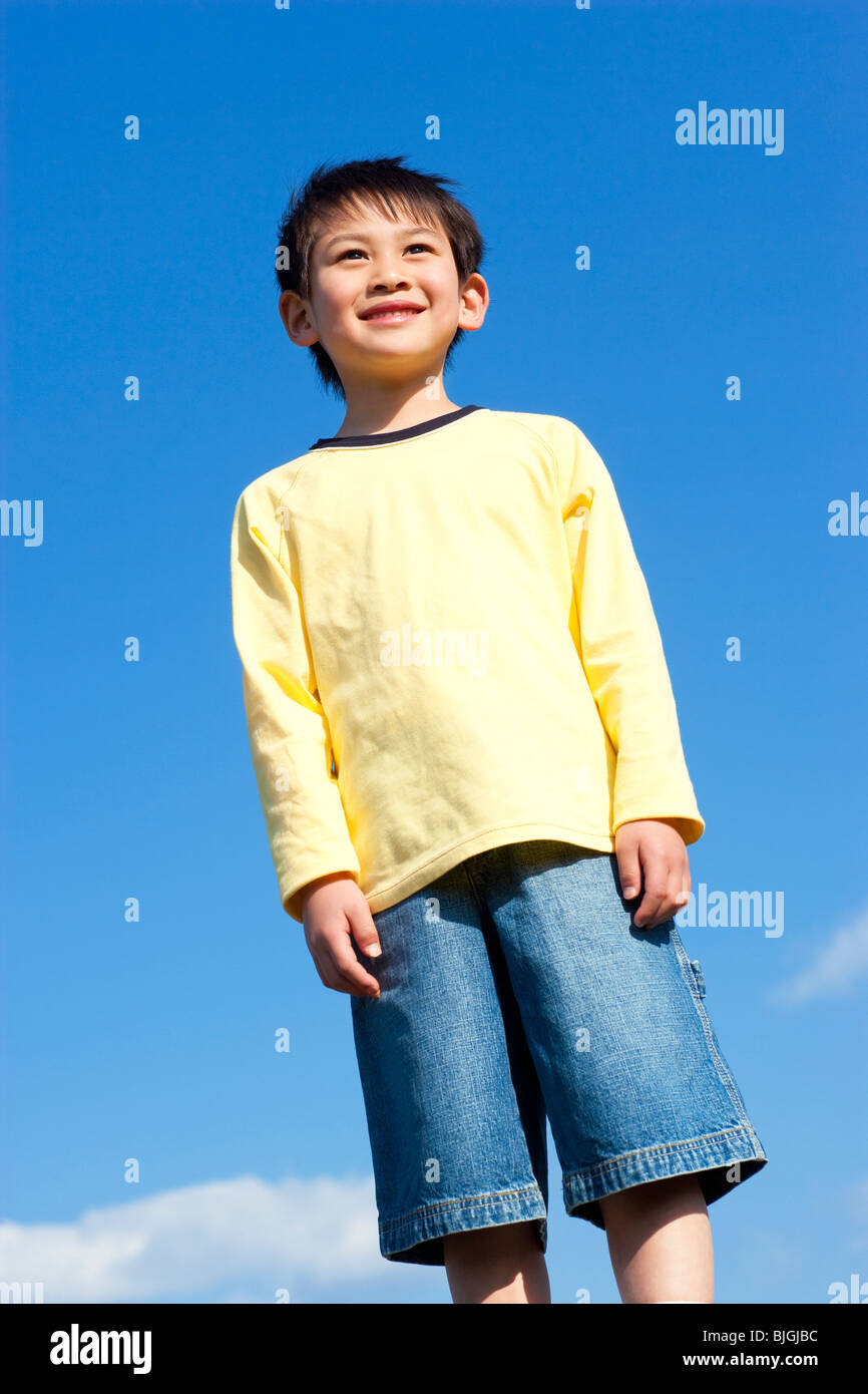 Portrait of young boy against a blue sky Stock Photo - Alamy