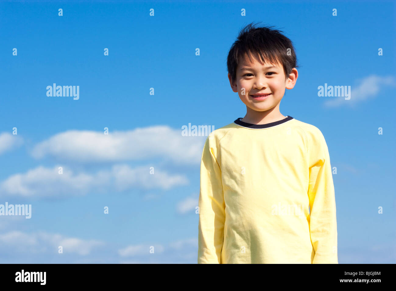 Portrait of young boy against a blue sky Stock Photo - Alamy