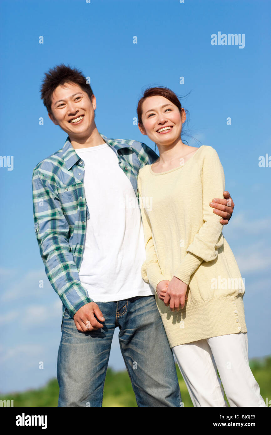 Young couple against a blue sky Stock Photo - Alamy