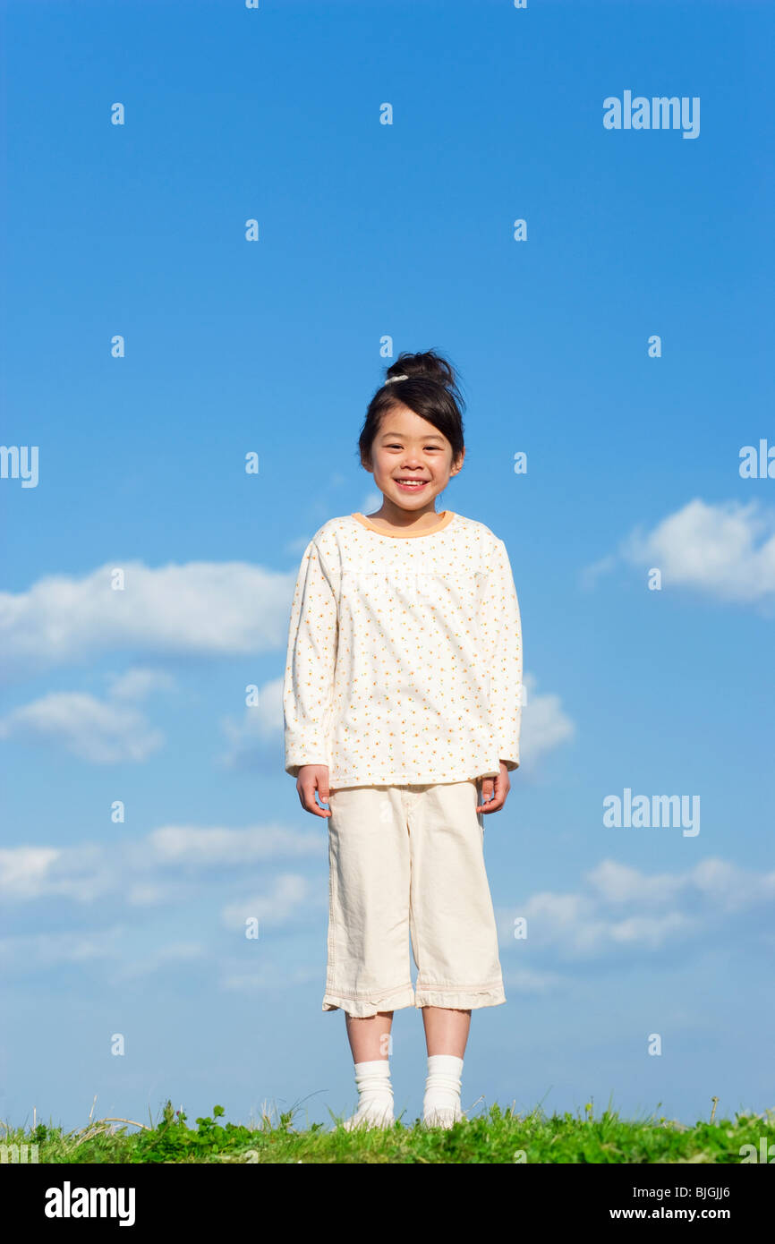 Portrait of young girl against a blue sky Stock Photo - Alamy
