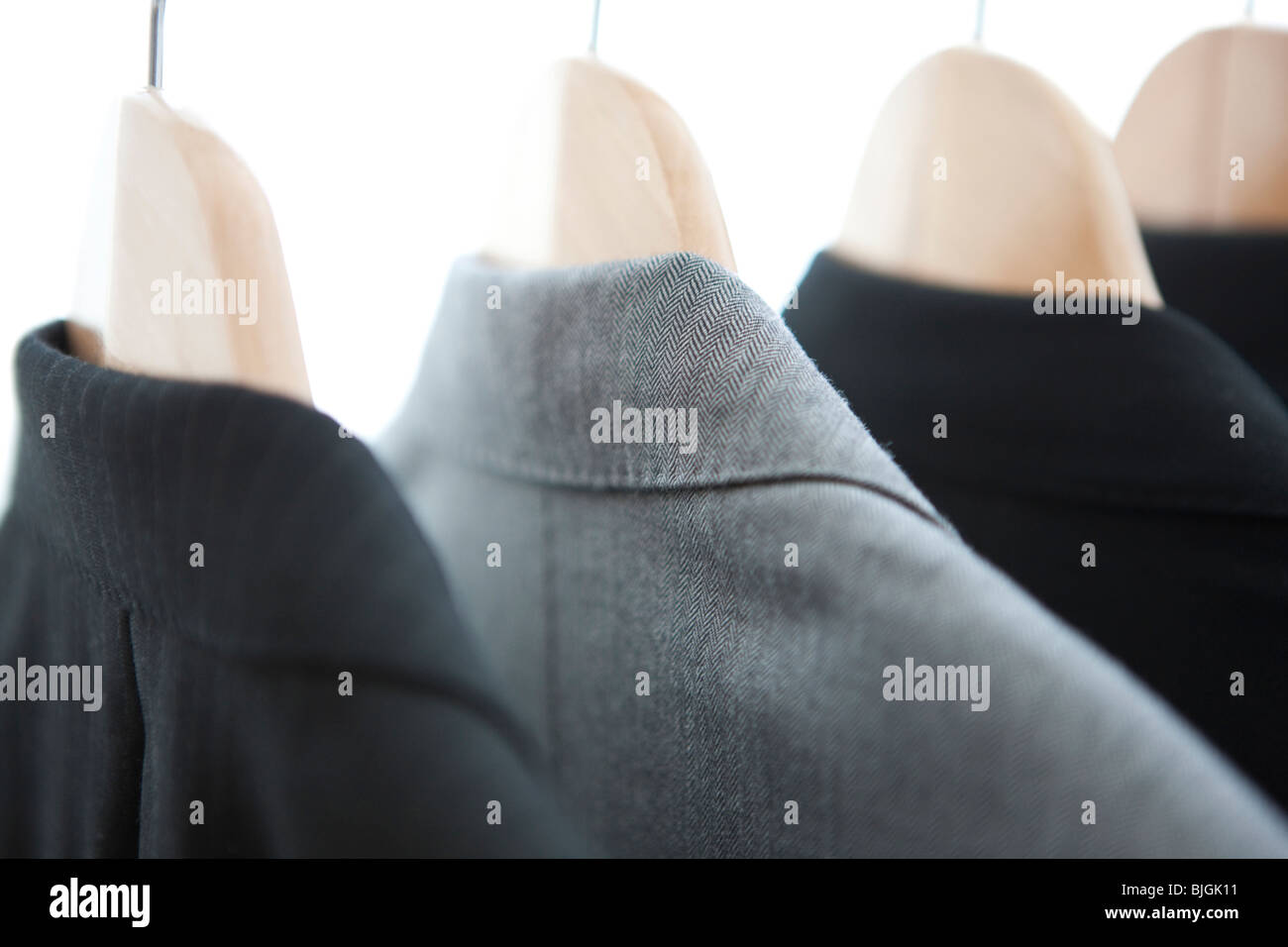 Suits on a clothes rack Stock Photo - Alamy