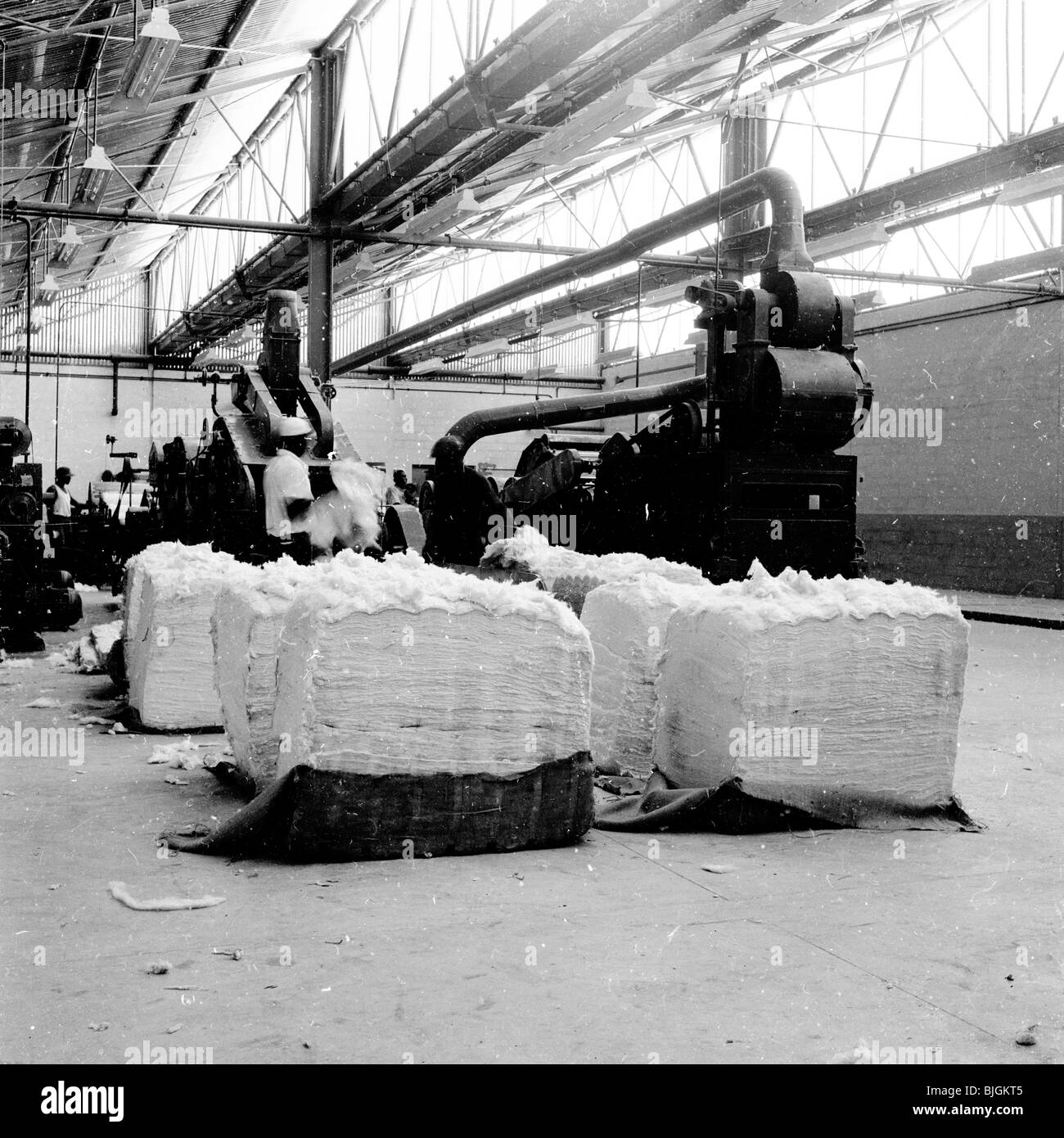Paper factory, England, 1950s. View of a machine in a warehouse used to