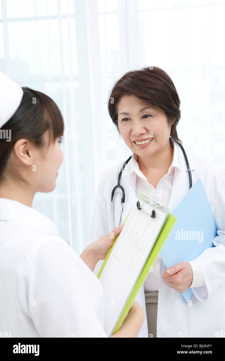 Mature doctor talking nurse hi-res stock photography and images - Alamy