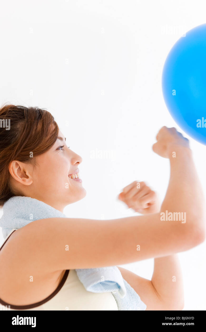 Woman punching a balloon Stock Photo Alamy