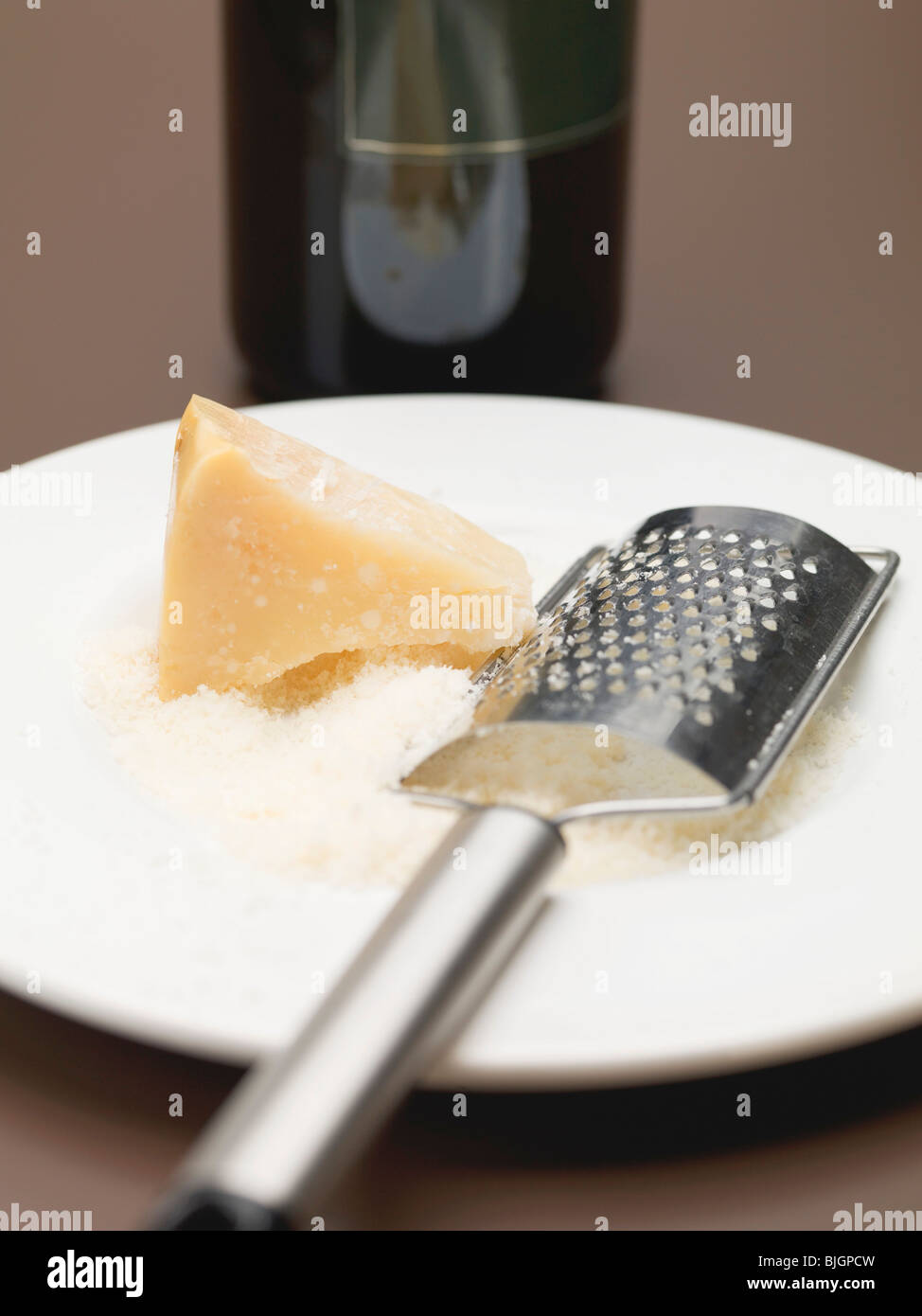 A block of Parmesan with a cheese grater on a slate plate Stock Photo -  Alamy