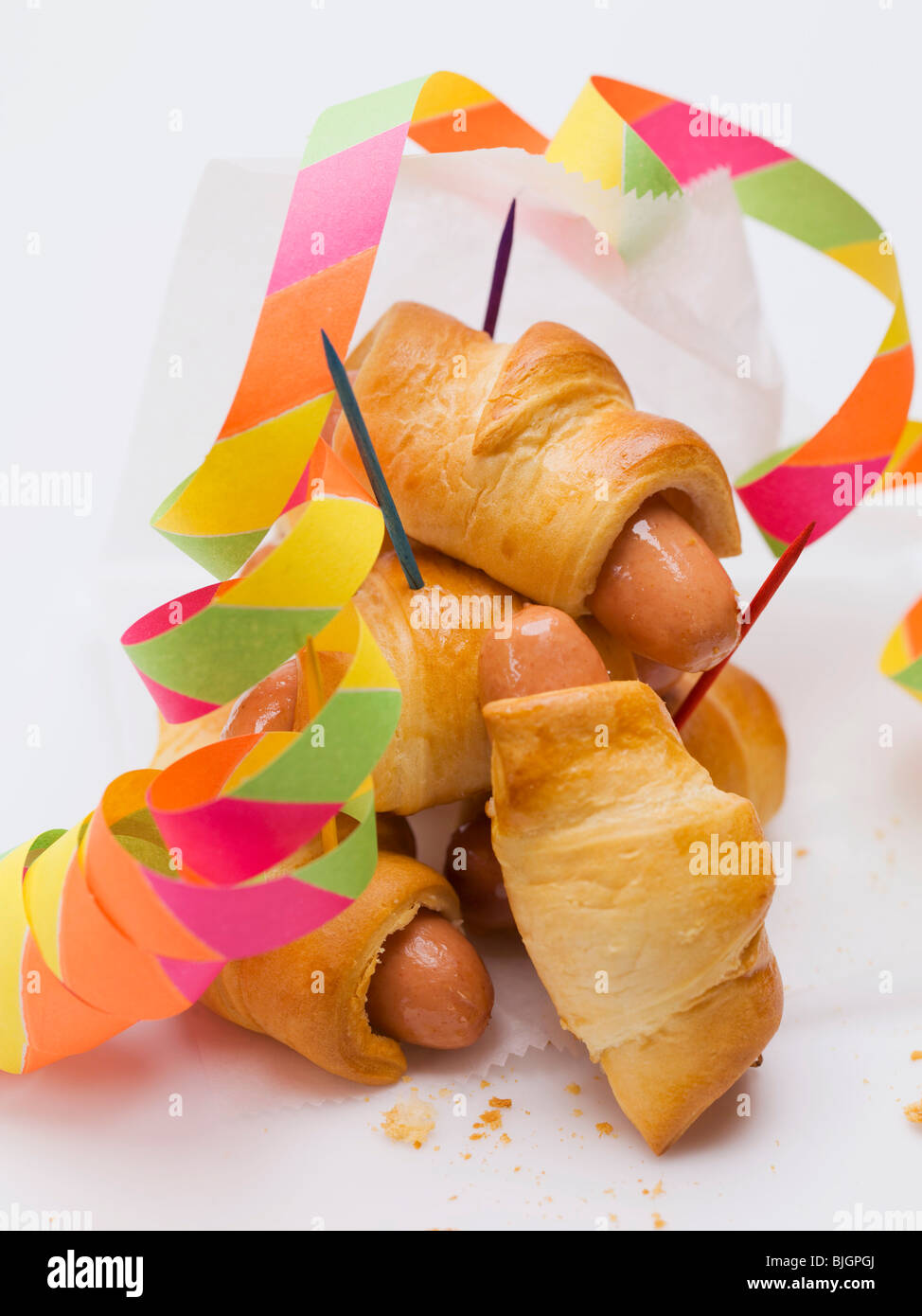 Sausage rolls with party decorations - Stock Photo