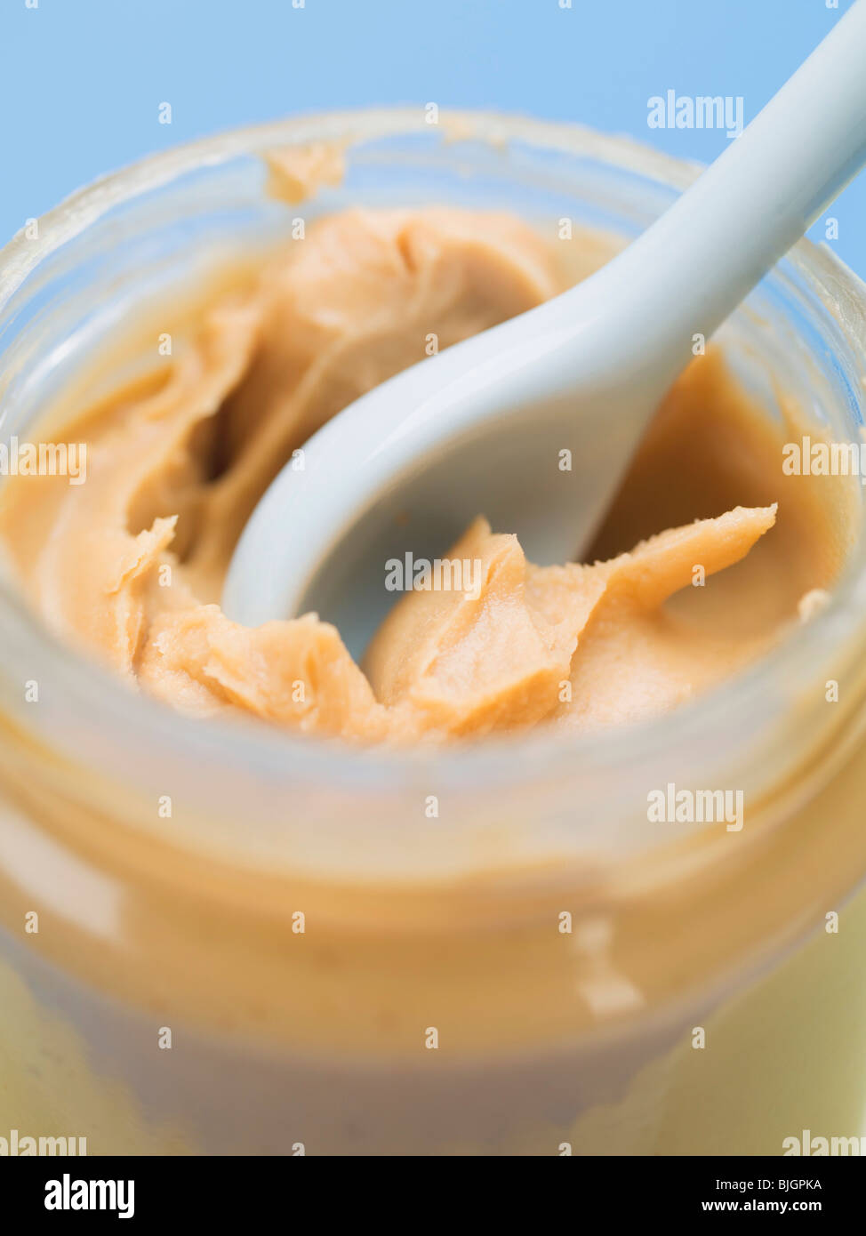 Peanut butter in jar with spoon (closeup Stock Photo Alamy