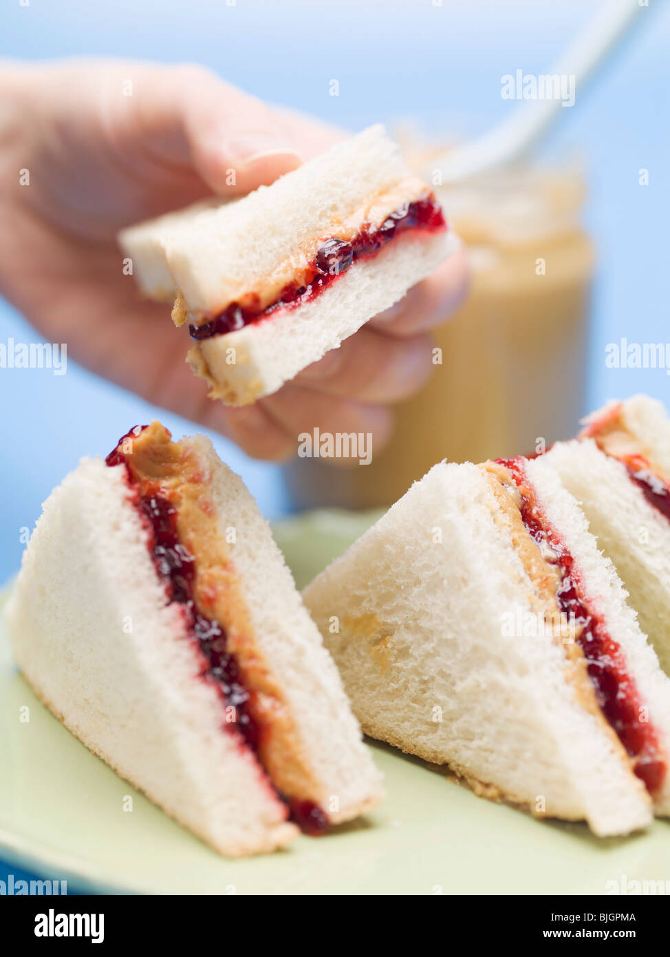 Hand holding peanut butter and jelly sandwich Stock Photo Alamy
