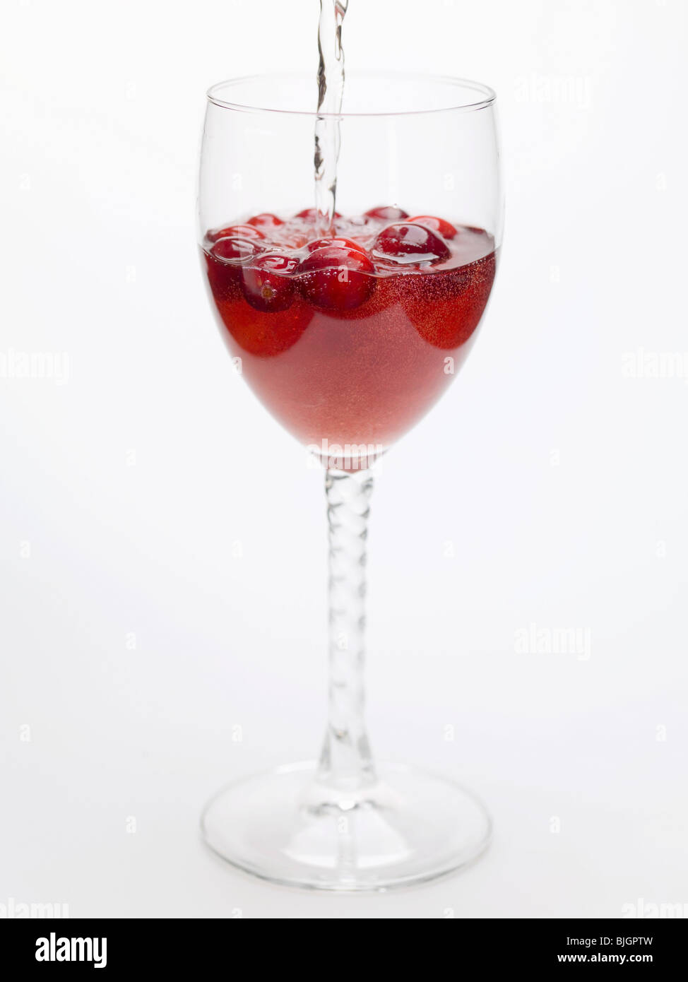 Adding water to cranberry drink - Stock Photo
