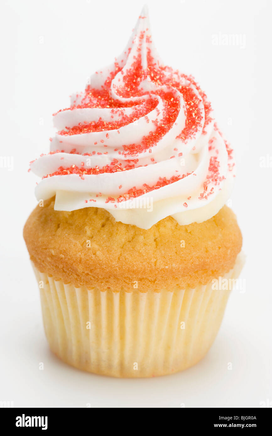 Cupcake with cream topping and red sugar - Stock Photo