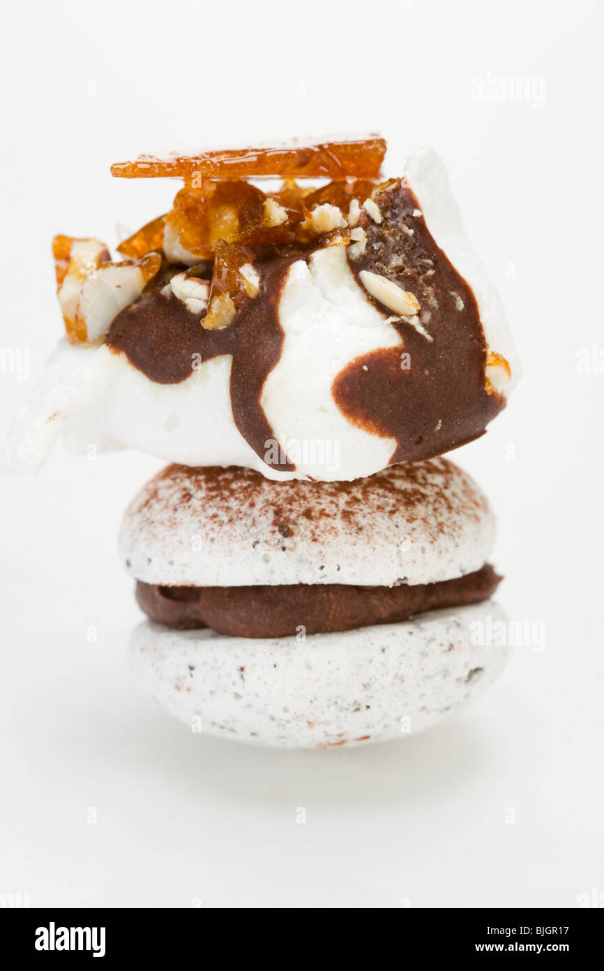 Meringue with chocolate & nut brittle, chocolatefilled macaron Stock Photo Alamy