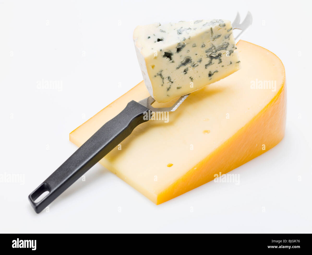 Pieces of Gouda and Gorgonzola with cheese knife - Stock Photo