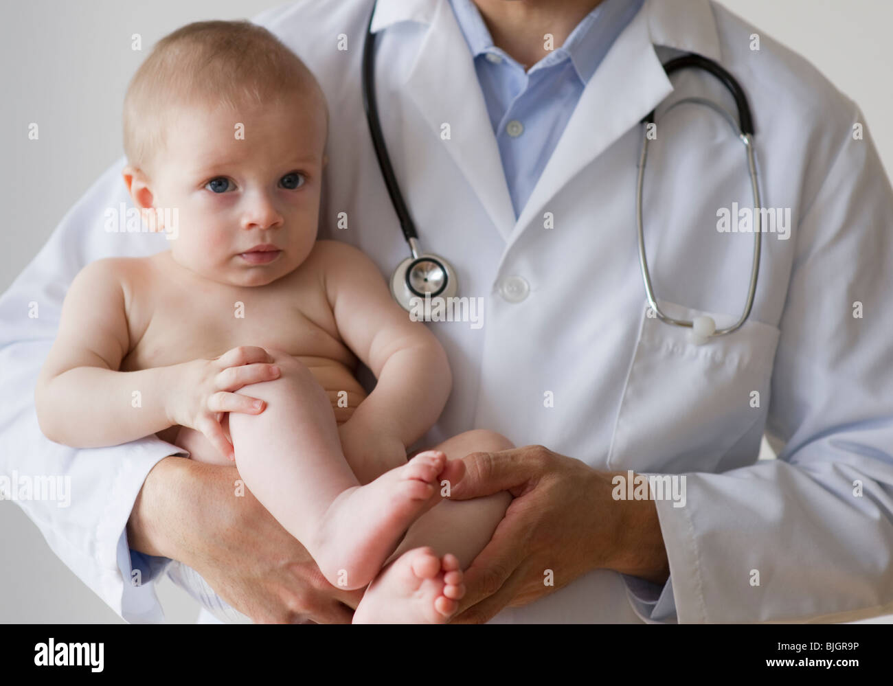 Doctor holding baby Stock Photo