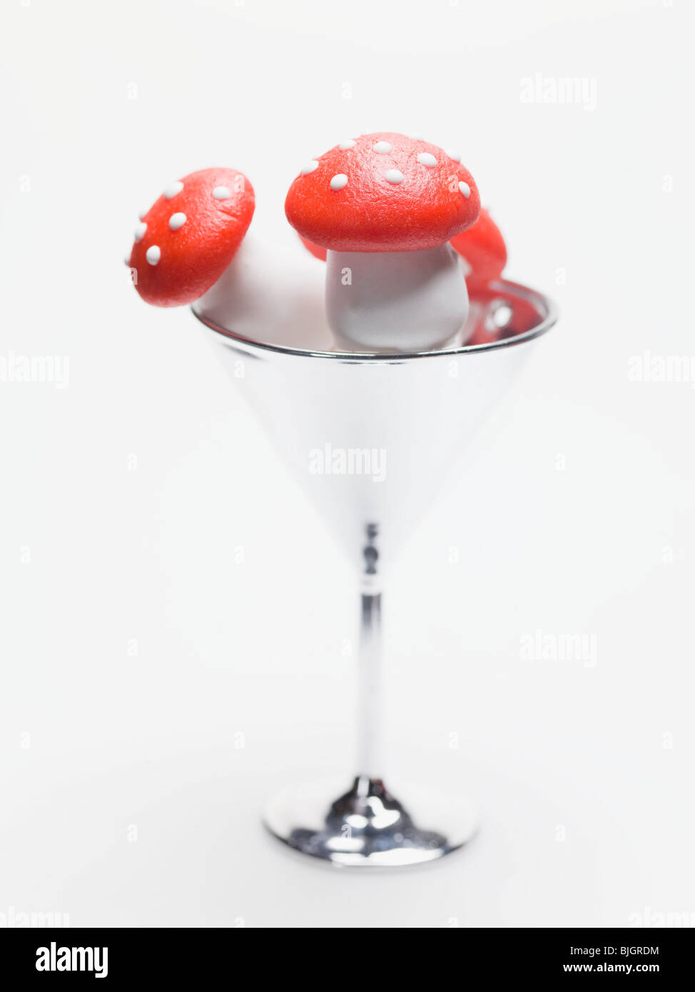 Marzipan fly agaric mushrooms in cocktail glass - Stock Photo