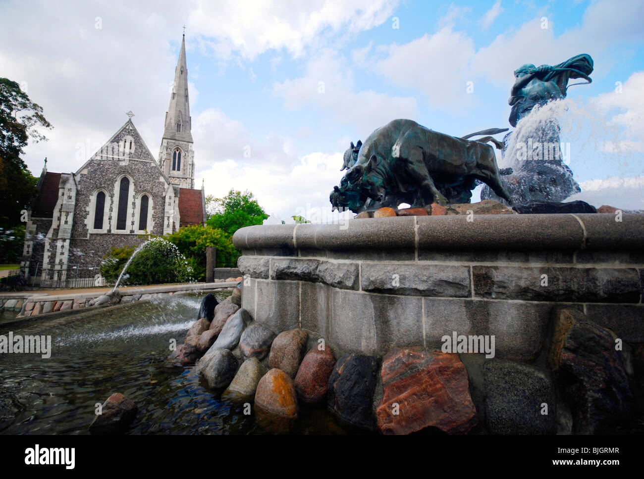 The Gefion Fountain (Danish: Gefionspringvandet) and St. Alban’s Church in Langelinie Park, Copenhagen, Denmark. Stock Photo
