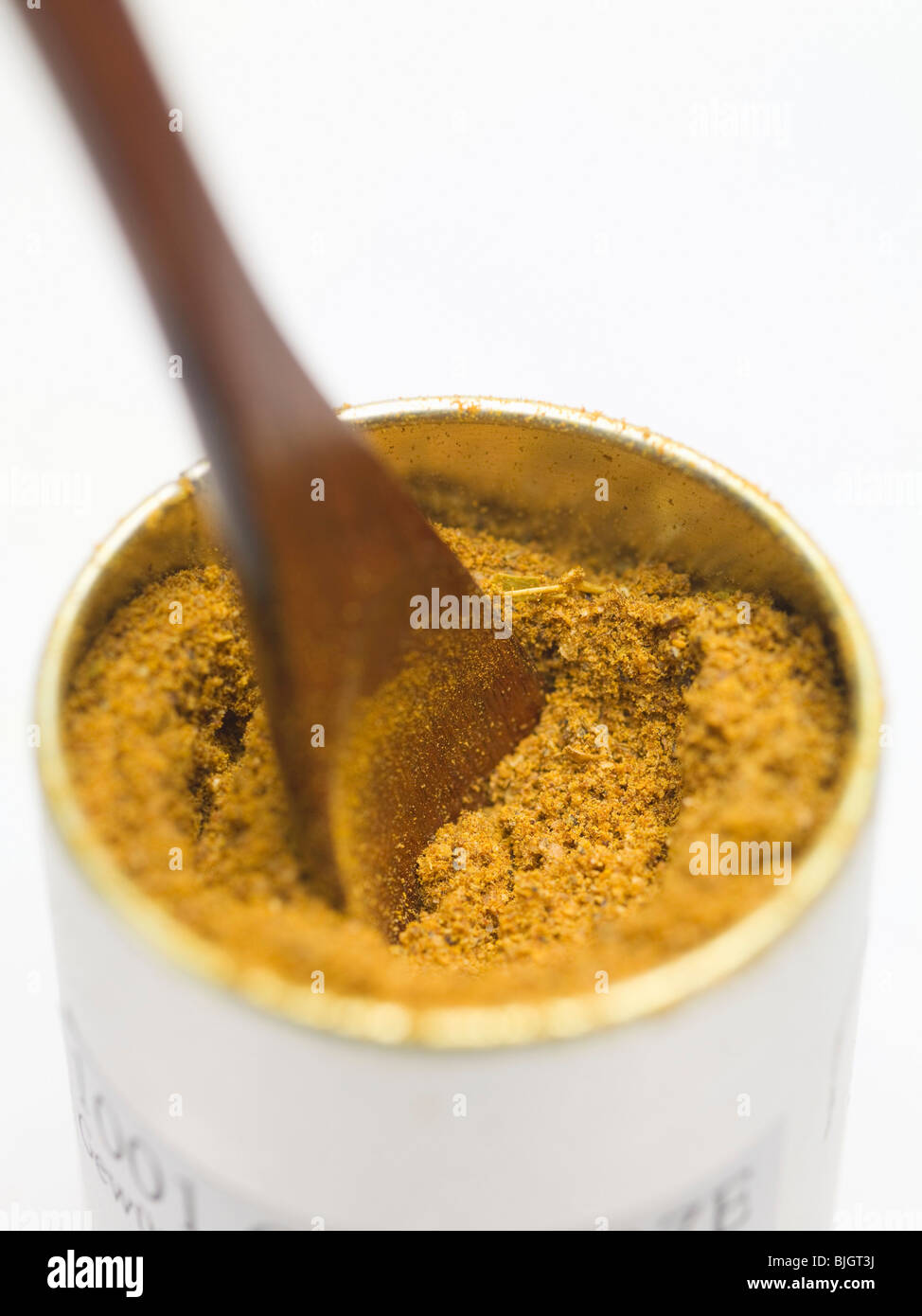 Indian curry powder in container - Stock Photo