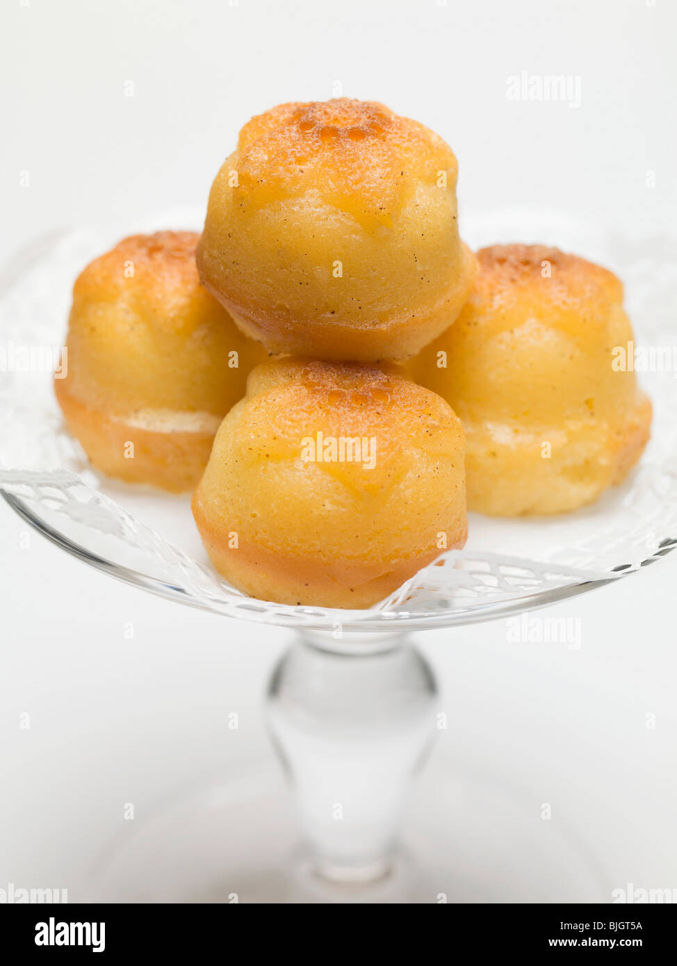 Rum babas on glass cake stand Stock Photo Alamy