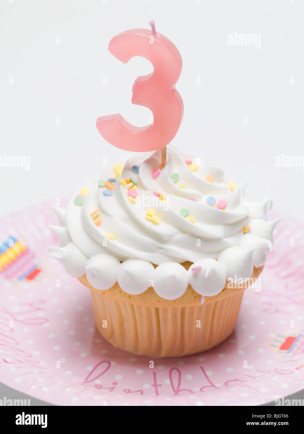 Birthday muffin with meringue topping and candle - Stock Photo