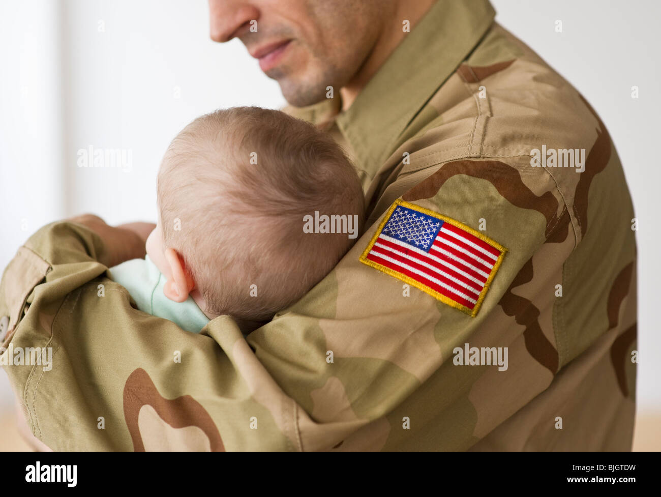 Soldier holding baby Stock Photo