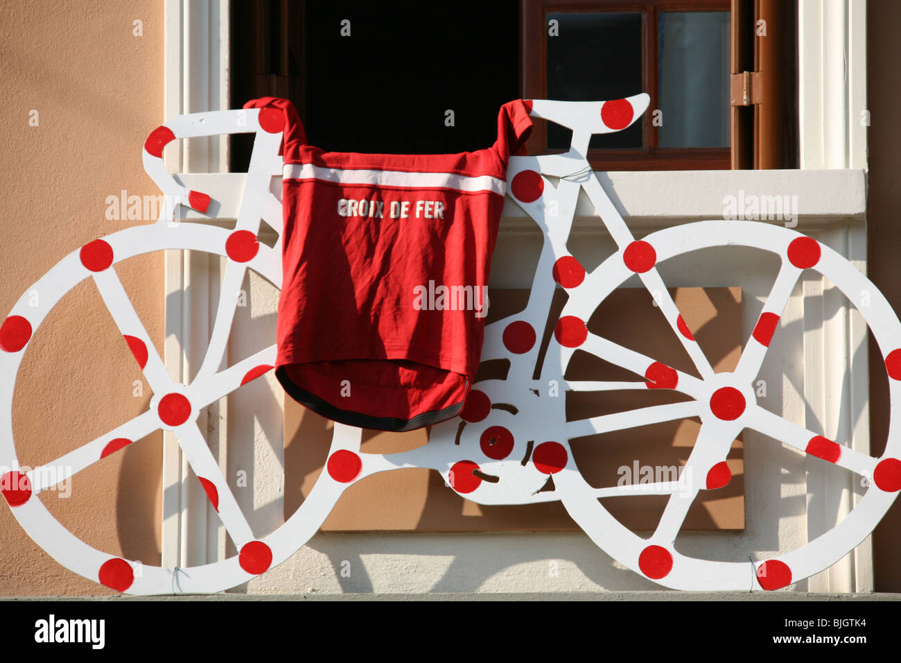 Bicycle sculpture painted in a red polkadots outside window of the St Georges Hotel, Tuscany, Italy, a popular cycling hotel. Stock Photo