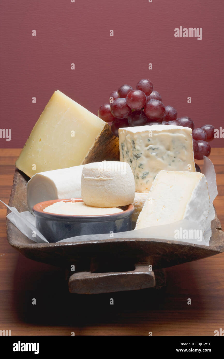 Cheese still life with red grapes Stock Photo Alamy