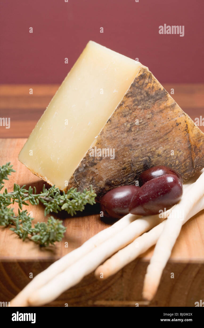 Pecorino with olives, thyme and grissini - Stock Photo