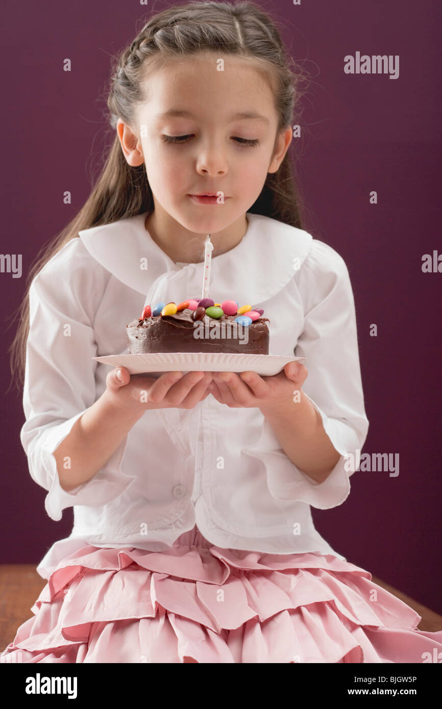 Little girl holding birthday cake Stock Photo Alamy