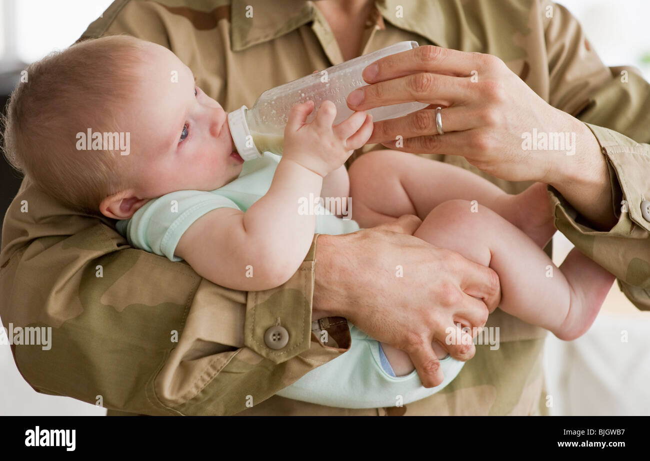 Feeding baby a bottle Stock Photo