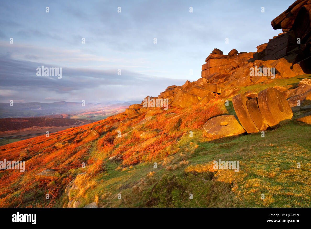 Abandoned millstones beneath Stanage Edge at first light in the Peak District National Park Stock Photo