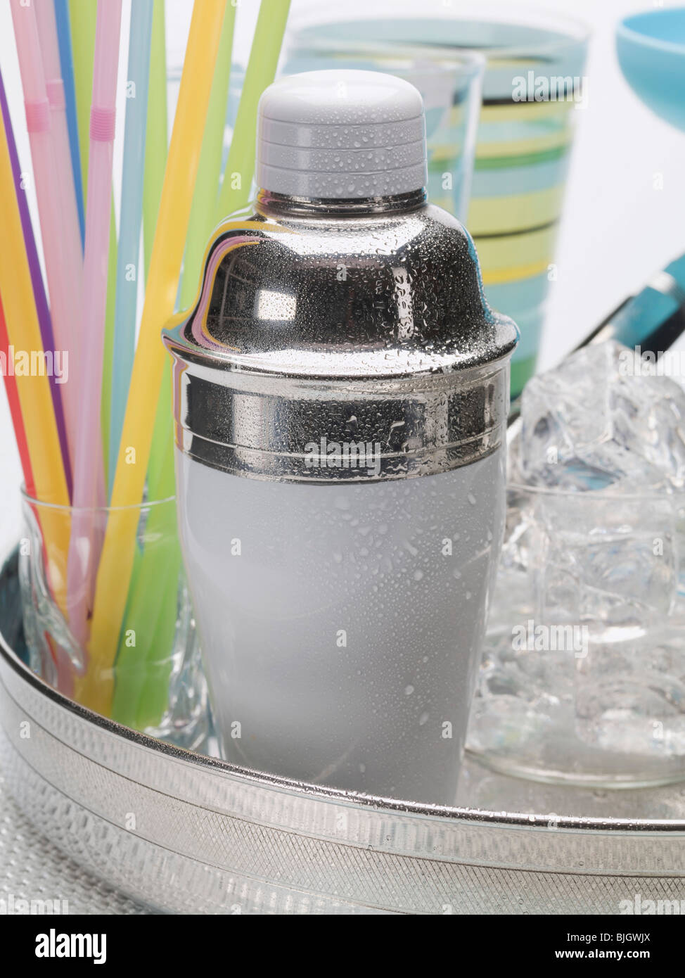 A cocktail shaker, ice cubes, glasses and straws Stock Photo Alamy