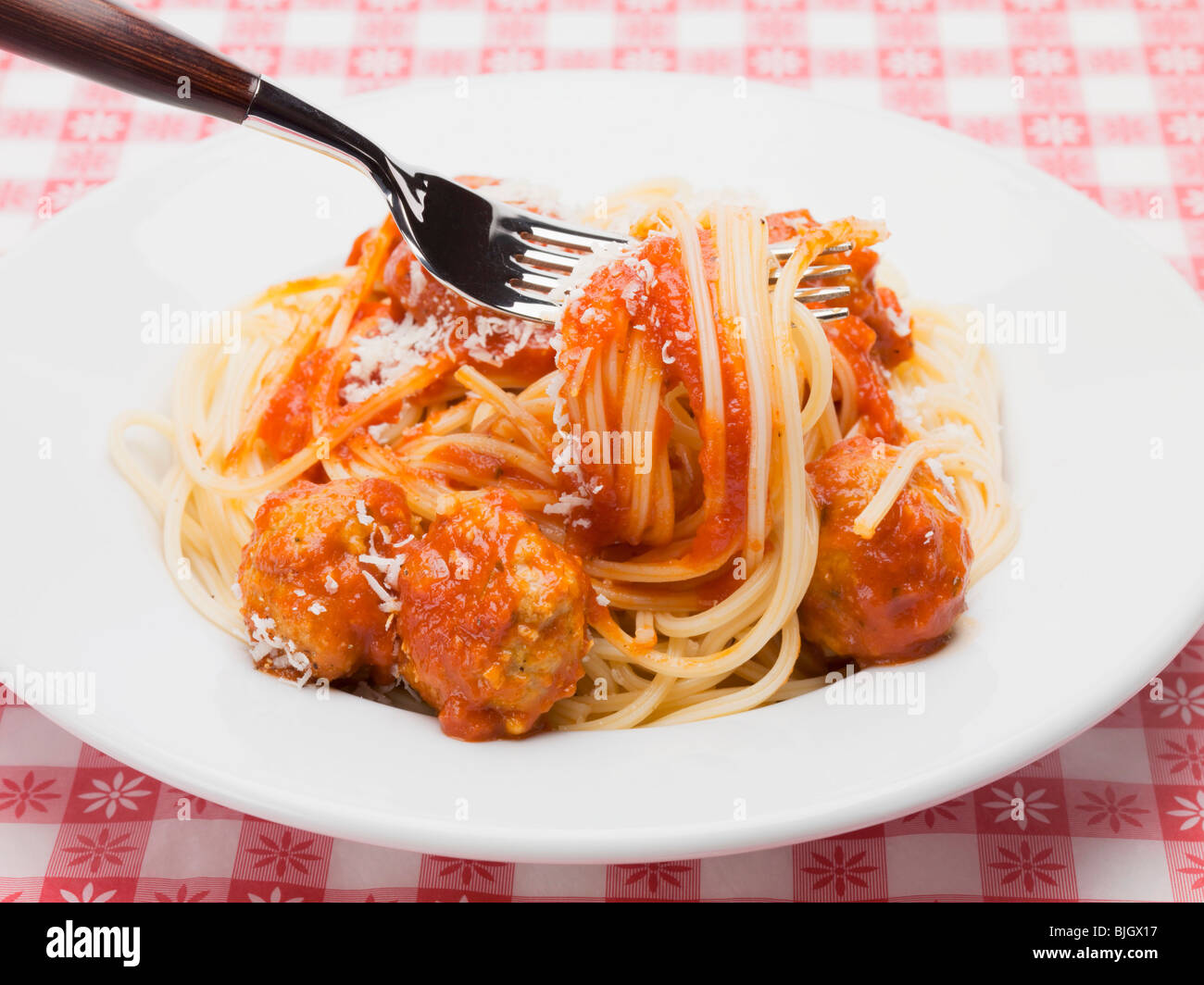 Mixing spaghetti and meatballs in tomato sauce Stock Photo - Alamy