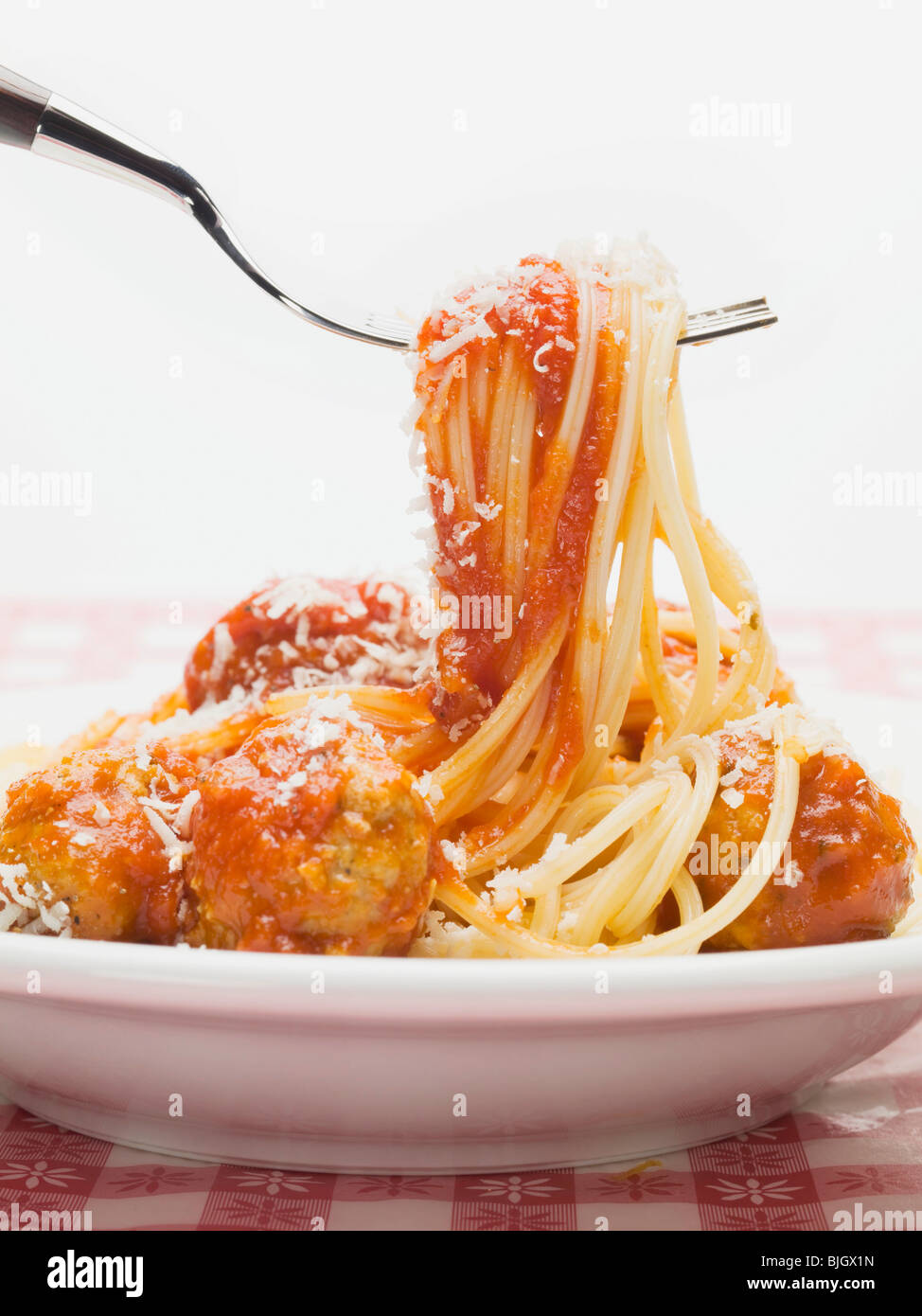 Mixing spaghetti and meatballs in tomato sauce Stock Photo - Alamy