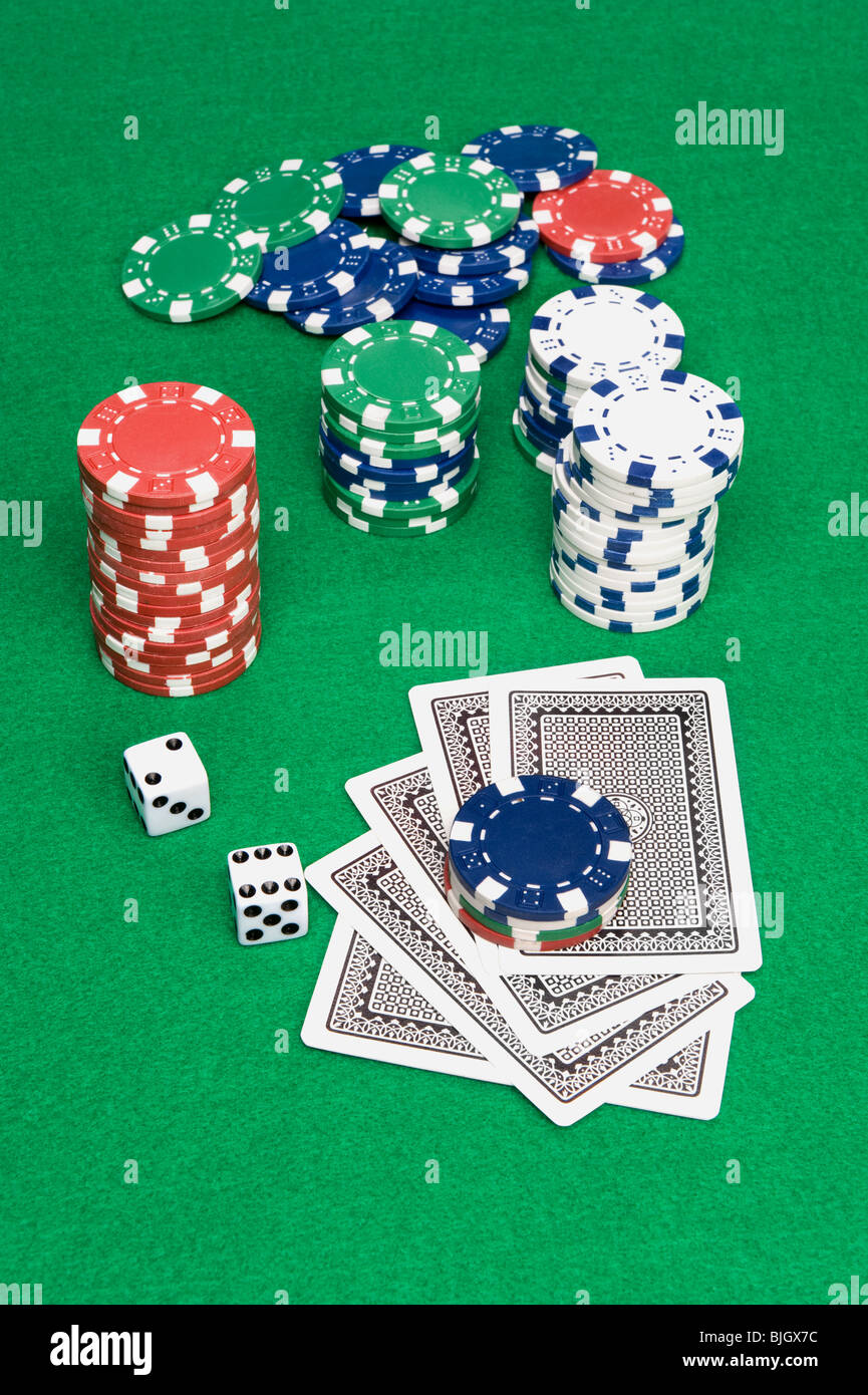 A setting of a poker game shows cards down and bet placed on top of the cards. Stock Photo