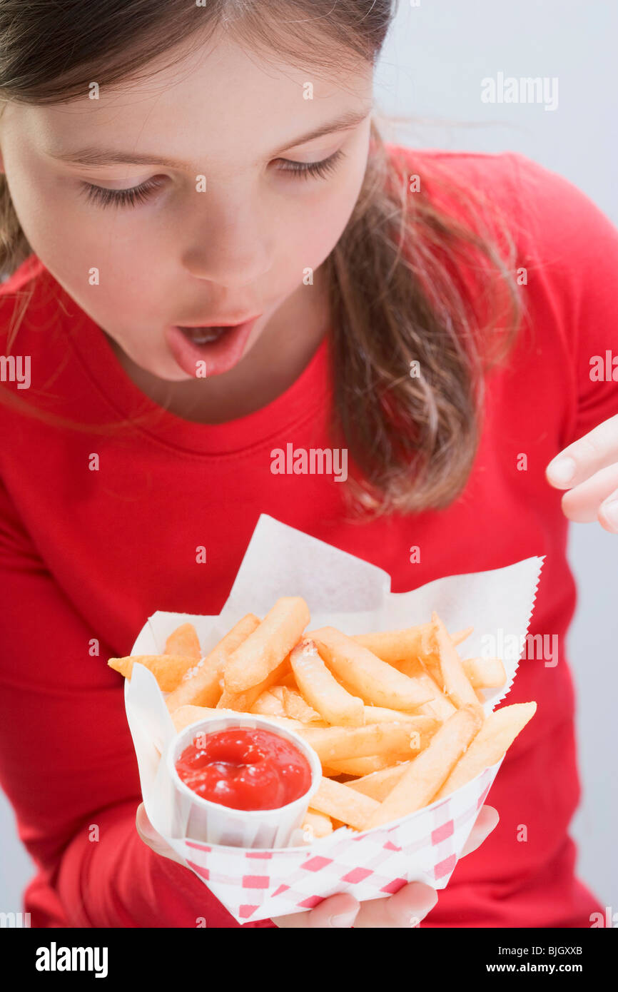 Girl Holding Chips With Ketchup Stock Photo Alamy girl-holding-chips-with-ketchup-stock-photo-alamy