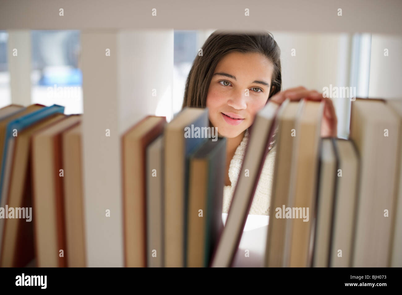 Student selecting book Stock Photo