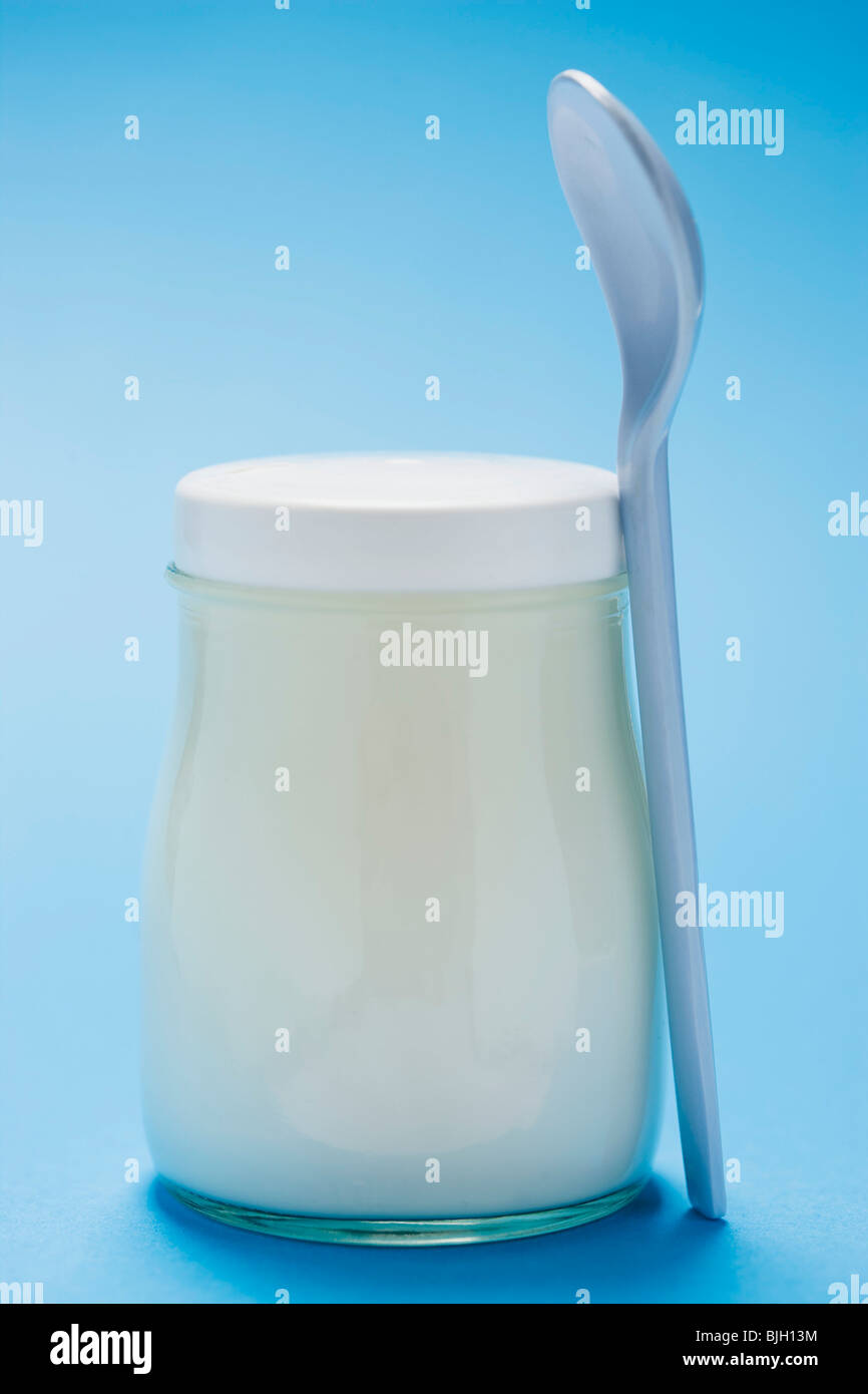 Natural yoghurt in jar, plastic spoon Stock Photo Alamy