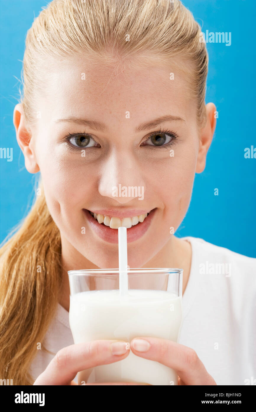 Woman drinking milk through straw hires stock photography and images Alamy