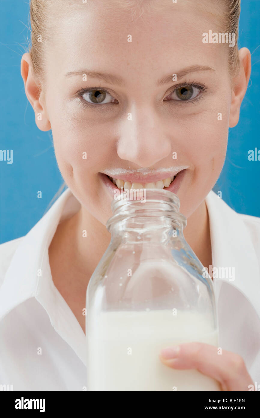 Young woman drinking milk out of the bottle Stock Photo Alamy