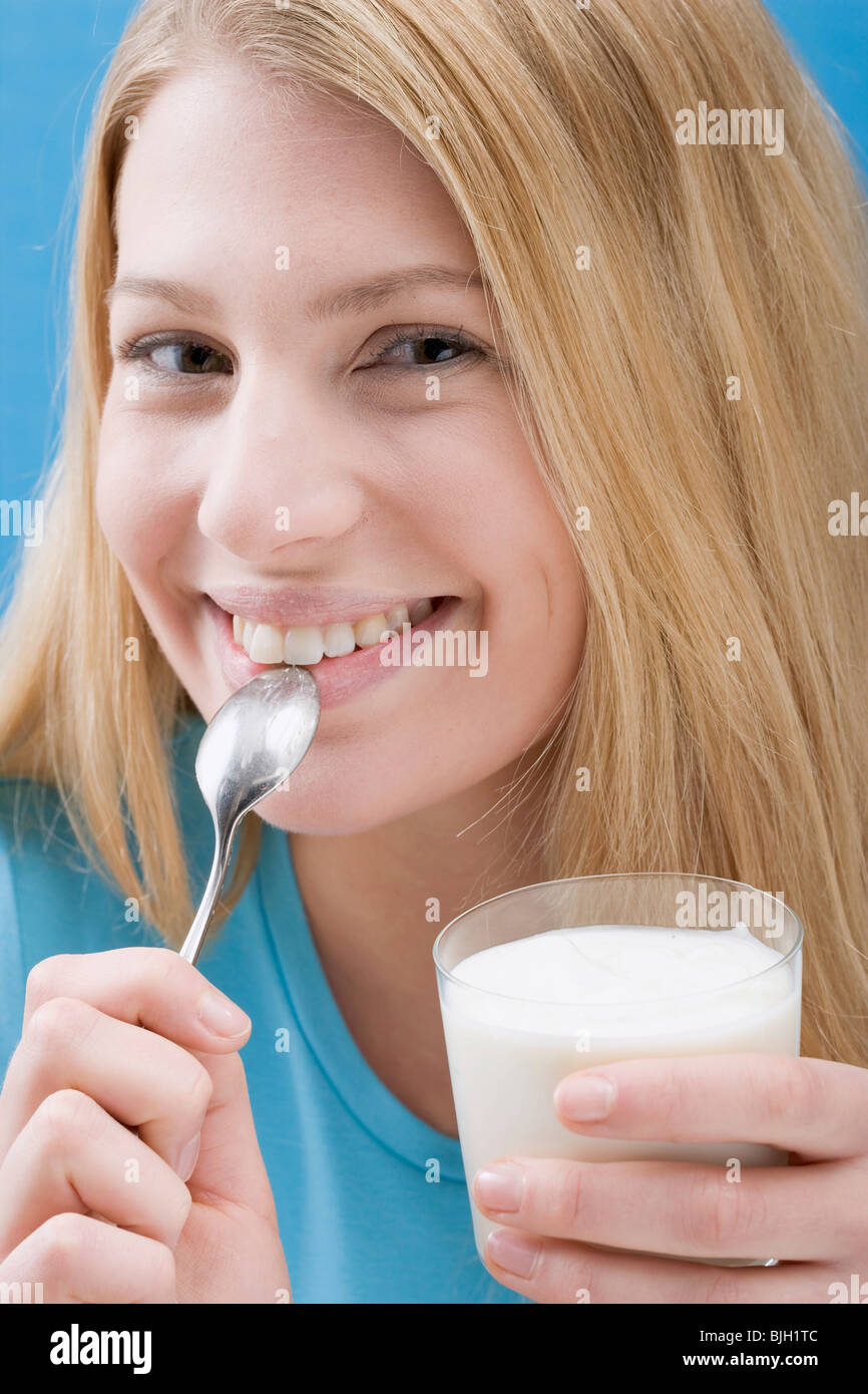 Young woman eating natural yoghurt Stock Photo Alamy